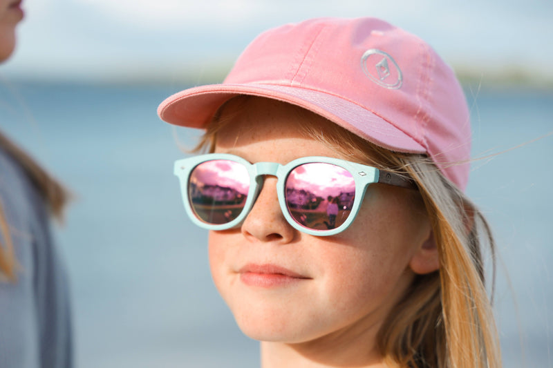 Made with a sustainable speckled wheatstraw frame with walnut wood temples, it's lightweight and comfortable. Fitted with UV400 polarised lenses. Our large child/teen/small adult frame and provides a neater fit without compromising on eye protection.