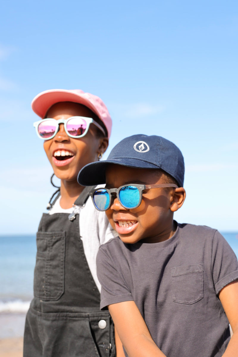 Made with a sustainable speckled wheatstraw frame with walnut wood temples, it's lightweight and comfortable. Fitted with UV400 polarised lenses. Our large child/teen/small adult frame and provides a neater fit without compromising on eye protection.