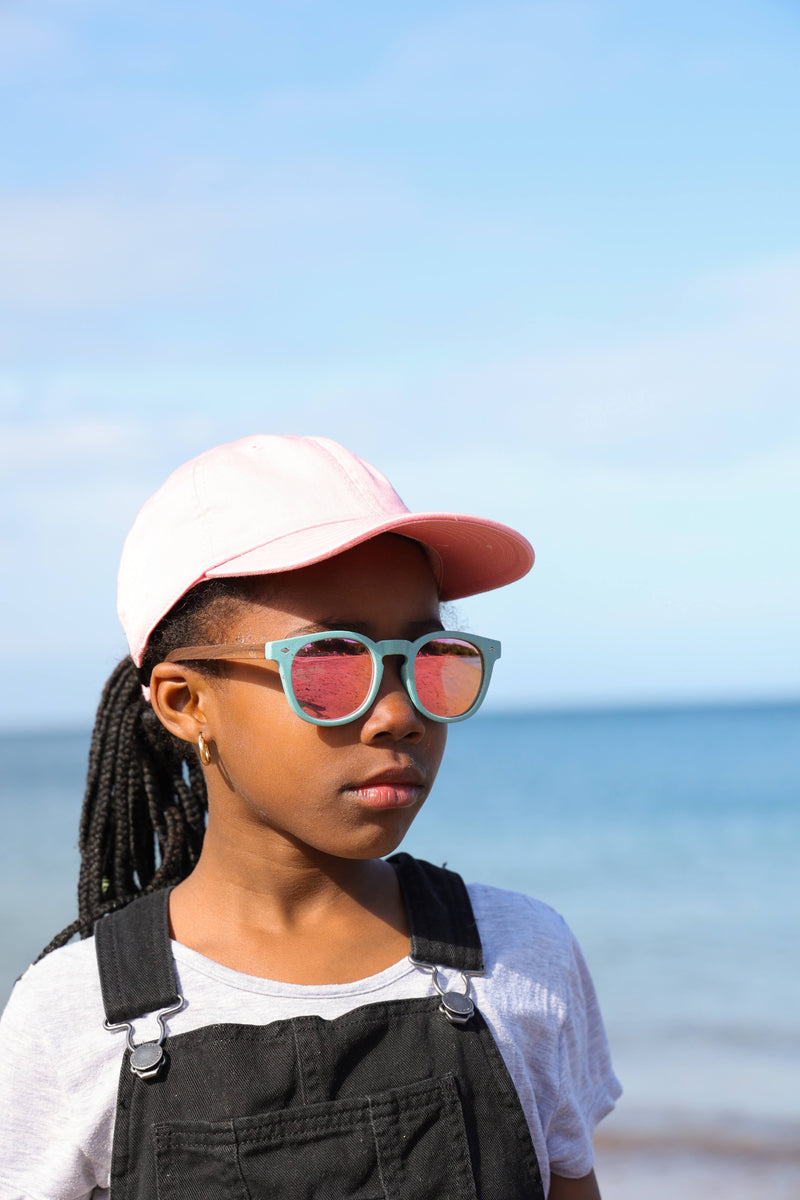 Made with a sustainable speckled wheatstraw frame with walnut wood temples, it's lightweight and comfortable. Fitted with UV400 polarised lenses. Our large child/teen/small adult frame and provides a neater fit without compromising on eye protection.