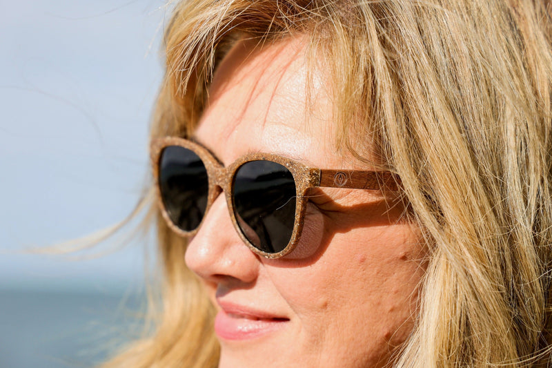 Made with a sustainable speckled wheatstraw or coffee residue frame and walnut wood temples, it's lightweight, comfortable and eco-friendly. Available in charcoal, olive green, coffee and mint frames and fitted with UV400 polarised lenses in smoke, mirrored rose pink and mirrored honey, they are a natural, biodegradable alternative to plastic sunglasses.