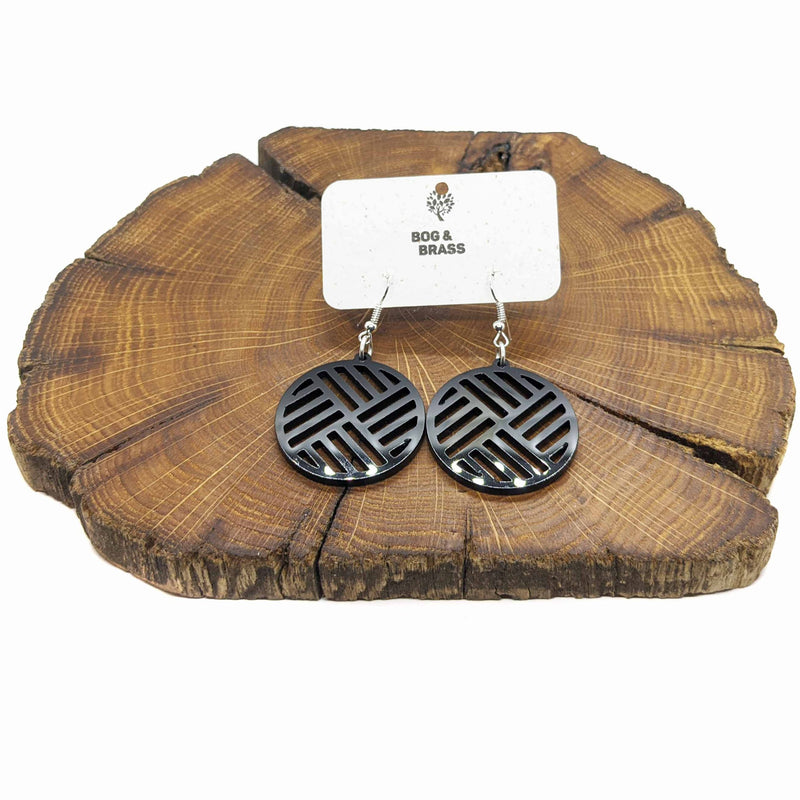 Black geometric quartered circle earrings in acrylic