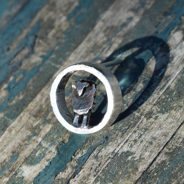 Silver circle black sheep lapel pin
